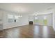 Spacious living room with a fireplace, large windows, and hardwood floors at 413 Edison Rail Ln, Knightdale, NC 27545