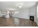 Bright, open-concept living room with a fireplace and adjacent kitchen area at 413 Edison Rail Ln, Knightdale, NC 27545