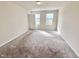 Bright bedroom with neutral carpeting and two windows at 1208 Fescue Rd, Rocky Mount, NC 27801