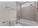 Tiled bathroom with a bathtub, shower head and modern fixtures at 416 S Cross St, Youngsville, NC 27596