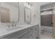 A luxurious bathroom with double sinks, quartz countertops, and updated faucets and hardware at 416 S Cross St, Youngsville, NC 27596