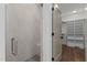 Bathroom featuring glass shower, tiled walls and access to a walk-in closet at 416 S Cross St, Youngsville, NC 27596