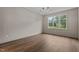 Bedroom with hardwood floors, trim detail, large window, and natural light at 416 S Cross St, Youngsville, NC 27596