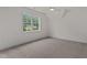 An inviting bedroom filled with plush carpeting, natural light, and a vaulted ceiling at 416 S Cross St, Youngsville, NC 27596