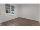 Cozy bedroom with hardwood floors and a large window at 416 S Cross St, Youngsville, NC 27596
