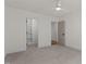 A comfortable bedroom with plush carpeting leading to closet and doorway at 416 S Cross St, Youngsville, NC 27596