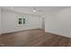 A spacious bedroom with laminate flooring, white walls, ceiling fan and natural light at 416 S Cross St, Youngsville, NC 27596