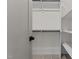 Organized closet featuring white shelving and rods, offering ample storage space with carpeted floors at 416 S Cross St, Youngsville, NC 27596