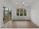 Bright dining room with chandelier and large window offering natural light at 416 S Cross St, Youngsville, NC 27596
