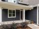 Inviting entryway with a bright red door and manicured landscaping at 416 S Cross St, Youngsville, NC 27596