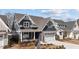 Charming new construction home features a two-car garage, landscaped yard and craftsman-style details at 416 S Cross St, Youngsville, NC 27596