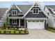 Beautiful home featuring navy siding, white trim, a two-car garage, and well-maintained lawn at 416 S Cross St, Youngsville, NC 27596