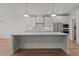 Modern kitchen featuring sleek white cabinets and a large center island at 416 S Cross St, Youngsville, NC 27596