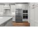 Gourmet kitchen features stainless steel appliances and white cabinets at 416 S Cross St, Youngsville, NC 27596