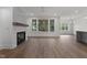 Bright living room with a cozy fireplace and natural light at 416 S Cross St, Youngsville, NC 27596