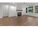 Comfortable living room featuring a fireplace, ceiling fan and natural light at 416 S Cross St, Youngsville, NC 27596