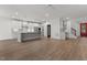 Spacious open floor plan with modern kitchen, bar area, and hardwood flooring at 416 S Cross St, Youngsville, NC 27596