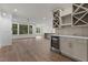 Bright and spacious living area with hardwood floors, built-in bar and view to the outdoors at 416 S Cross St, Youngsville, NC 27596