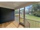 Screened porch with wood floors offers a relaxing space with views of the surrounding landscape at 416 S Cross St, Youngsville, NC 27596