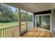 Inviting screened porch with a wood floor, a ceiling fan, access to backyard, and lots of natural light at 416 S Cross St, Youngsville, NC 27596