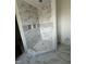 Elegant bathroom shower boasting marble tiles, mosaic accents, and convenient built-in niches at 103 Slocum Dr, Wendell, NC 27591