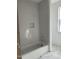 Bright bathroom featuring a tiled shower-tub, built-in niche, and elegant marble flooring at 103 Slocum Dr, Wendell, NC 27591