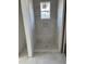 Bathroom shower tiled in calming gray tones featuring a built-in niche and a window at 103 Slocum Dr, Wendell, NC 27591