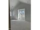 Unfinished bedroom with high ceilings and natural light from large windows overlooking the surrounding trees at 103 Slocum Dr, Wendell, NC 27591