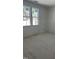 An unfinished bedroom features bright natural light from large windows overlooking the wooded neighborhood at 103 Slocum Dr, Wendell, NC 27591