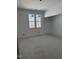 Unfinished bedroom with bright natural light from large windows, offering beautiful views of the surrounding trees at 103 Slocum Dr, Wendell, NC 27591
