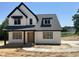 New two-story home features a modern farmhouse design with a black roof and clean white siding at 103 Slocum Dr, Wendell, NC 27591