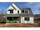 New two-story home featuring light grey siding, a dark grey roof, and a wood front door under a sunny blue sky at 103 Slocum Dr, Wendell, NC 27591