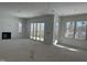 An unfinished living room featuring ample natural light with a fireplace and sliding doors leading to the outdoors at 103 Slocum Dr, Wendell, NC 27591