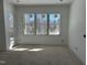 Spacious living room with large windows providing ample natural light and views of the surrounding landscape at 103 Slocum Dr, Wendell, NC 27591
