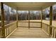 Cozy back porch surrounded by trees, offering a serene outdoor living space at 168 Grand Griffon Way, Lillington, NC 27546