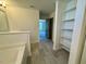 Bathroom featuring a bathtub with tile accents, open shelving, and tile flooring at 168 Grand Griffon Way, Lillington, NC 27546