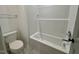 Bathroom with a white bathtub and shower combination with tile flooring at 168 Grand Griffon Way, Lillington, NC 27546