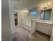 Bright bathroom featuring a soaking tub, dual vanities, and a walk-in closet at 168 Grand Griffon Way, Lillington, NC 27546