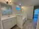 Modern bathroom featuring a tub, dual sinks, tile flooring, and a glass shower at 168 Grand Griffon Way, Lillington, NC 27546