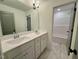 Bright bathroom featuring a double vanity, large mirror, and access to the tub at 168 Grand Griffon Way, Lillington, NC 27546