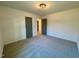 Bright carpeted bedroom features recessed lighting, neutral walls, and access to en suite bath at 168 Grand Griffon Way, Lillington, NC 27546