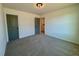 Carpeted bedroom with neutral walls, overhead lighting, and doors to closet and en suite at 168 Grand Griffon Way, Lillington, NC 27546