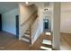 Hallway with hardwood floors and staircase leading to upper level at 168 Grand Griffon Way, Lillington, NC 27546