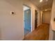 Hallway with hardwood floors, neutral paint, and views of bedrooms and bathrooms at 168 Grand Griffon Way, Lillington, NC 27546