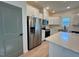 Kitchen boasts stainless appliances, quartz counters, an island, and white cabinets at 168 Grand Griffon Way, Lillington, NC 27546