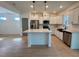 Open kitchen with an island, stainless appliances, and white cabinetry at 168 Grand Griffon Way, Lillington, NC 27546