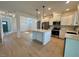 Bright kitchen features a central island, stainless appliances, and modern white cabinetry at 168 Grand Griffon Way, Lillington, NC 27546