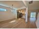 Open-concept living space with hardwood floors and modern lighting at 168 Grand Griffon Way, Lillington, NC 27546
