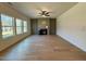 Spacious living room with hardwood floors, ceiling fan, and fireplace at 168 Grand Griffon Way, Lillington, NC 27546