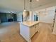 View from kitchen island into living room with fireplace and staircase at 168 Grand Griffon Way, Lillington, NC 27546